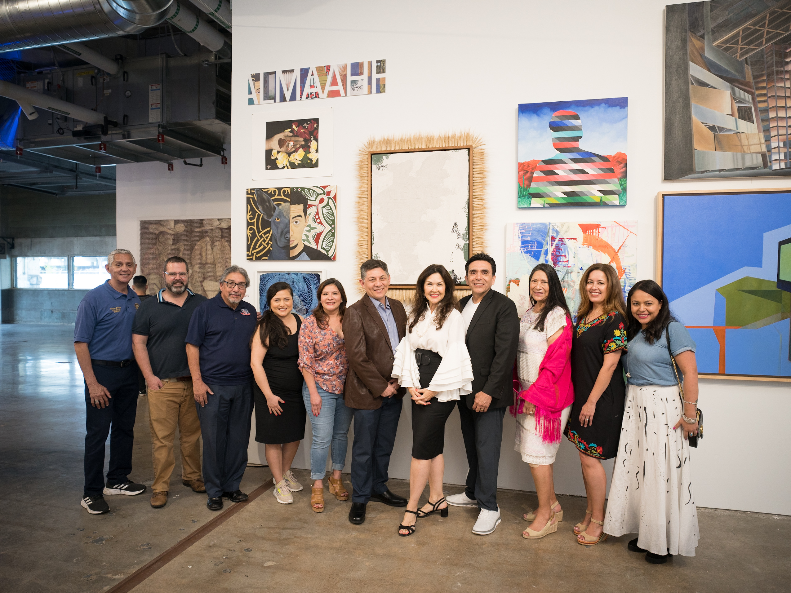 ALMAAHH founding supporters gathered in front of artwork at POST Houston