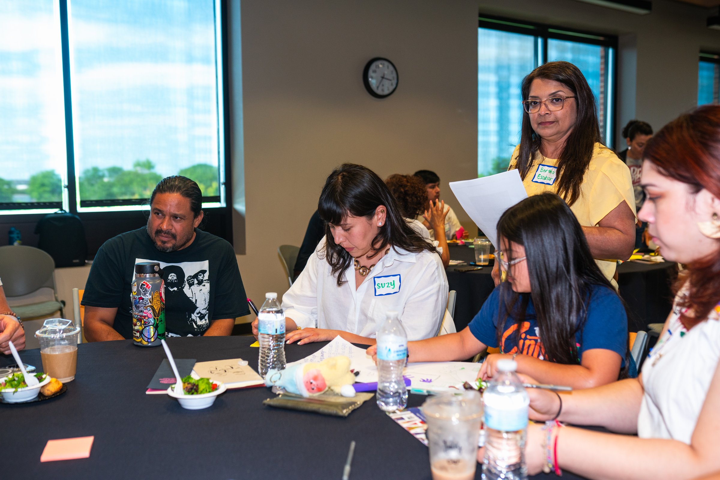 Community members collaborating at a visioning session working group table