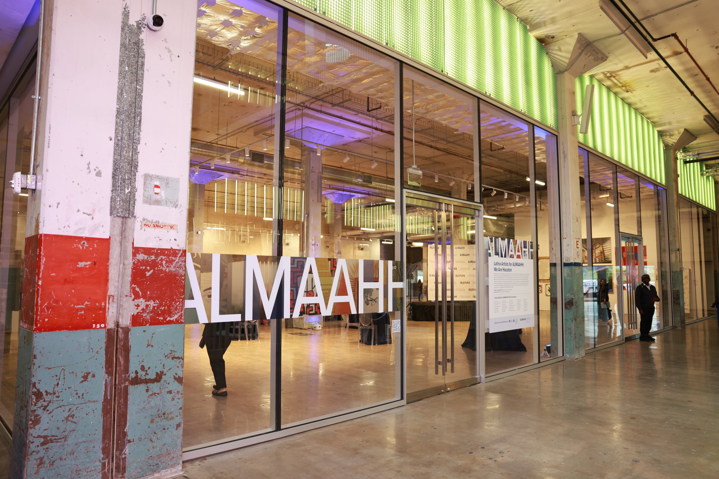 Latinx Artists for ALMAAHH: We Are Houston exhibition gallery at POST Houston with visitors viewing artwork on display walls
