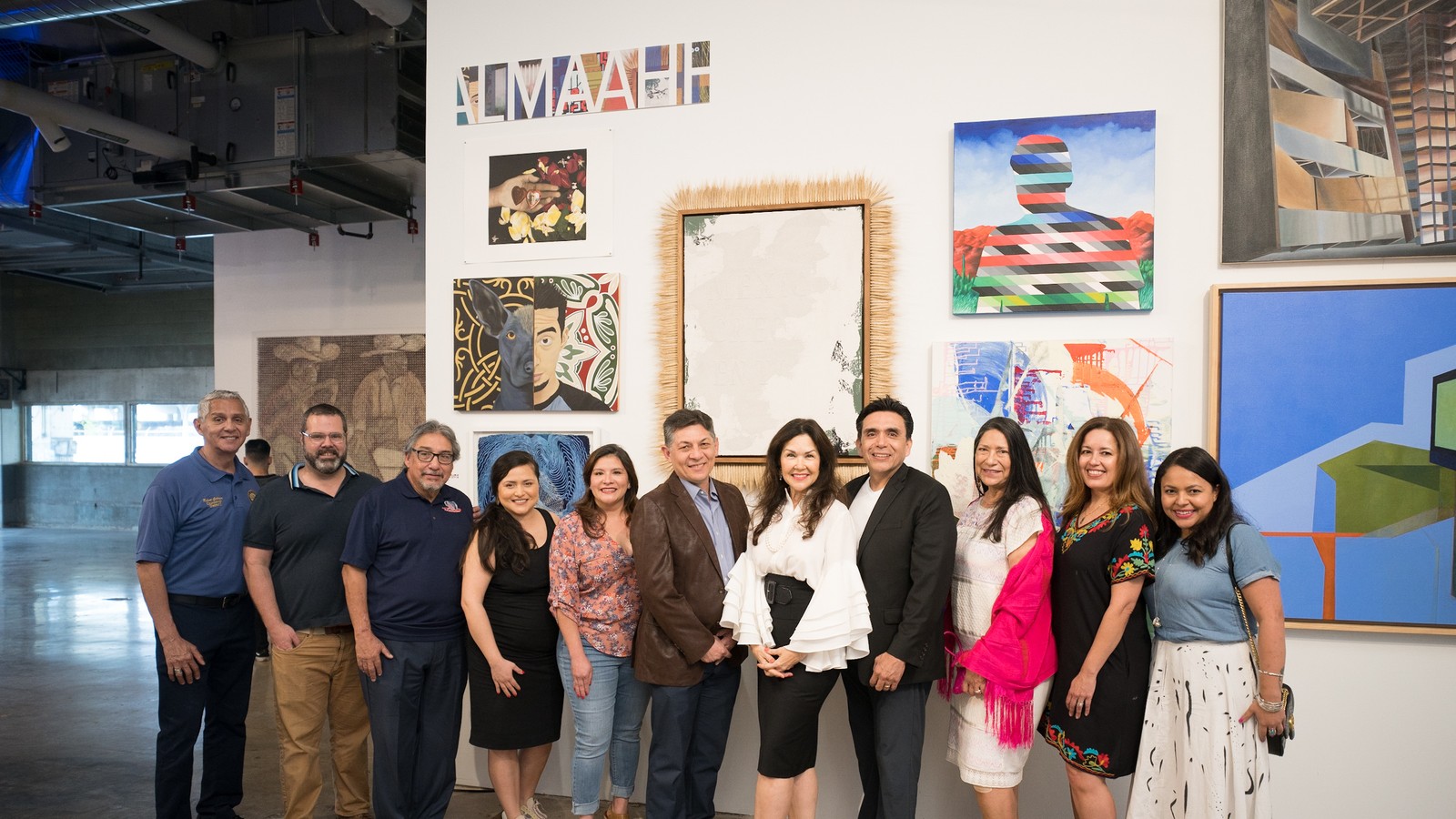 ALMAAHH board and staff members standing together inside the future Latino museum and cultural center space.